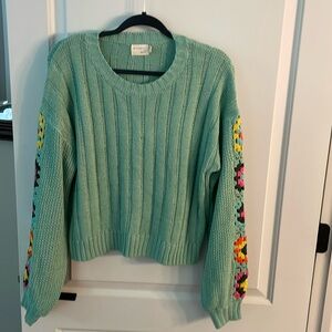 Women’s knit sweater with crochet flower sleeves. Size M/L